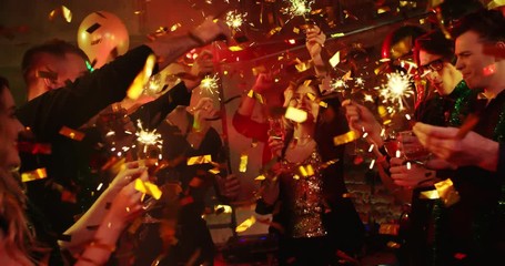 Happy New Year. Young people are firing bengal lights at a nightclub. They are celebrating New Year and Christmas - Powered by Adobe