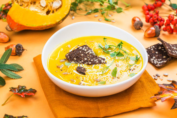 Pumpkin soup on autumn background