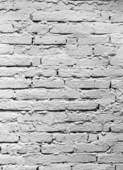 Brick wall, roughly folded and covered with whitewash