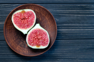  fruits of figs on a black wood background