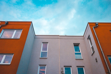 facade of modern white and red colored row houses at germany