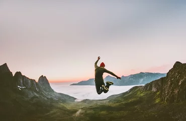 Foto op Plexiglas Jumping man in mountains vacations outdoor Travel Lifestyle adventure concept active success motivation and fun euphoria emotions © EVERST