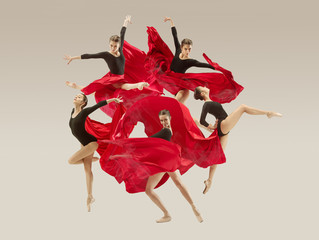 Modern ballet dancer exercising in full body on white studio background. Ballerina or female dancer with silk fabric dancing on white studio background. Caucasian model on pointe shoes