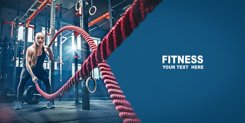 Fototapeta Woman with battle rope battle ropes exercise in the fitness gym. gym, sport, rope, training, athlete, workout, exercises concept obraz