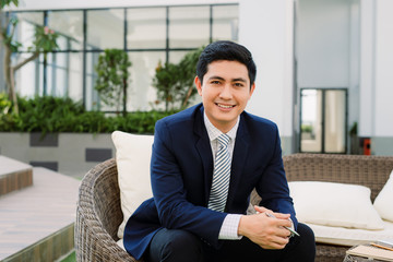 Successful intelligent business man relaxing in a restaurant outdoors, confident thoughtful entrepreneur,  waiting someone in the modern coffee shop terrace