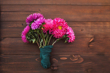 asters autumn bouquet of brightly colored wooden background