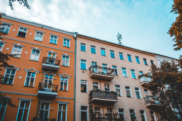 brown and orange apartments with low saturated sky in the background