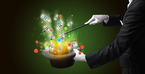 Illusionist conjure with magic wand gambling things from a cylinder