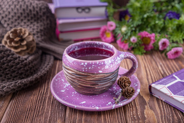 Fruit tea, books and flowers asters on a wooden background