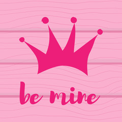 Hand drawn pink crown on a white background. With the text be mine on a wooden background