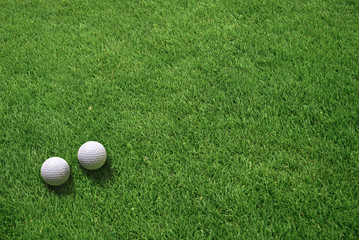 Top View of Two White Golf Balls Lying on Green Grass