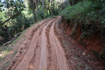 dirty broken rural road with deep tire tracks, take pictures  on the car