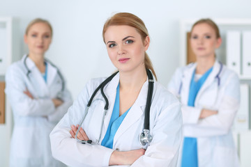 Fototapeta premium Group of medical doctors standing at hospital. Team of physicians ready to help patients. Medicine and health care concept