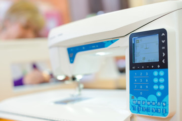 Closeup of electronic sewing machine - Powered by Adobe