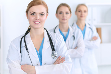 Group of medical doctors standing at hospital. Team of physicians ready to help patients. Medicine and health care concept