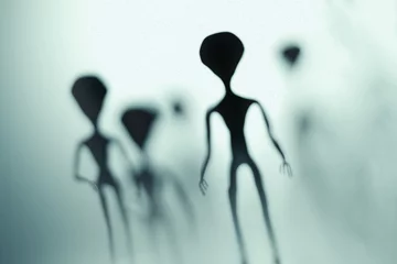 Fotobehang Spooky silhouettes of aliens and bright light in background. 3D rendered illustration. © vchalup
