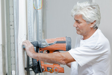 Builder using a nail gun