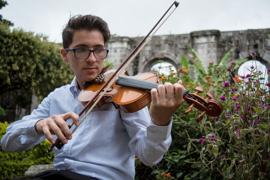 portrait of young violinist outside the castle