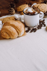 Winter and autumn hot drink. Hot chocolate or cocoa with marshmallow , cookies and spices on white and wooden background.