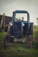 Fototapeta premium Little girl over a tractor. Farmer's Daughter.