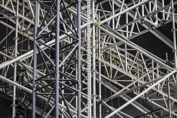 Background of metal construction of a portable concert stage with illuminators.