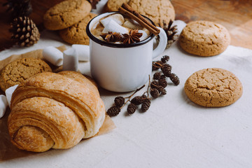 Winter and autumn hot drink. Hot chocolate or cocoa with marshmallow , cookies and spices on white and wooden background.