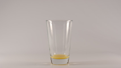 Empty Glass after an orange juice on a white background