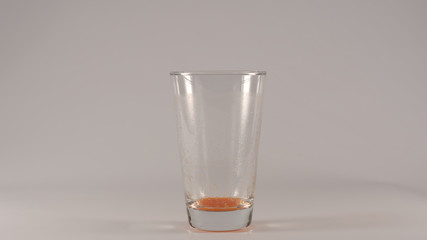 Empty Glass after an tomato juice on a white background