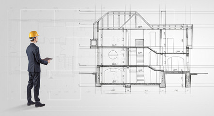 Architect watching a 2 dimension house plan
