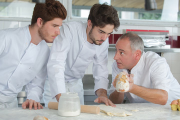 young chefs preparing food in the kitchen at the restaurant