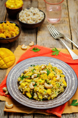 Curry chicken rice with mango and parsley
