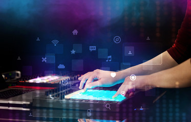 Obraz na płótnie Canvas Hand mixing music on dj controller with social media concept icons 