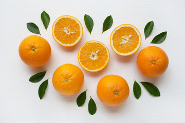 Fresh orange citrus fruit with leaves isolated on white background.