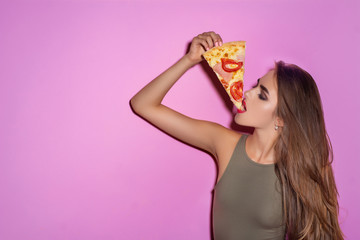 One pretty young sexy woman with long hair and bright makeup holding tasty big slice of pizza ready...