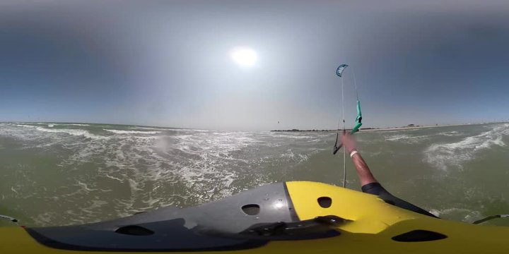 Active lifestyle. First-person view, a man in a helmet with a camera, kitesurfing, quickly skates the sea on waves