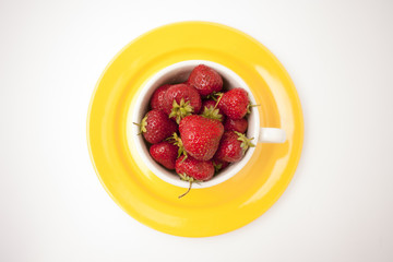 Strawberry on bright yellow plate