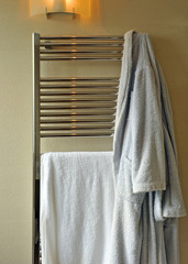 Towels and bathrobe over the bathroom heater, modern and cozy house