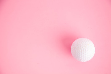golf ball on pink background