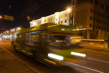 Fototapeta na wymiar The motion of a blurred bus in the street in the evening.