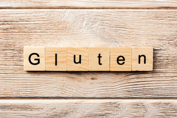 gluten word written on wood block. gluten text on table, concept