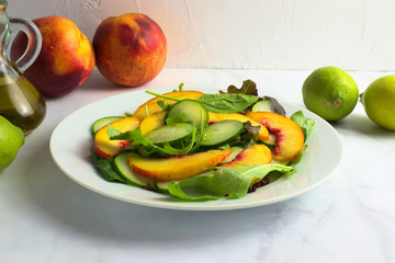 Fresh salad made of greens and nectarines