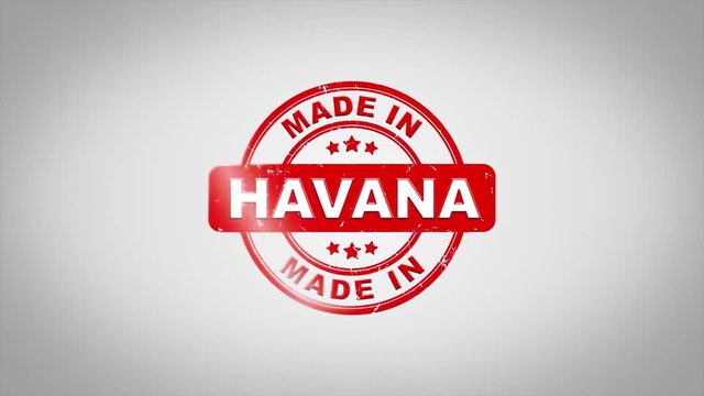 Made In HAVANA Signed Stamping Text Wooden Stamp Animation. Red Ink on Clean White Paper Surface Background with Green matte Background Included.