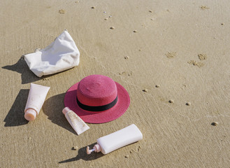 Sunscreen, bag, hat On the beach in summer.