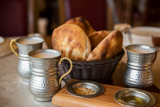 Simple Turkish national food. Cakes and milk drink ayran in a beautiful old dish.
