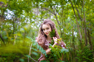 a young  teenager girl in a pink costume in the park