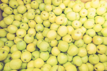 green apples background in box at street market, retro toned