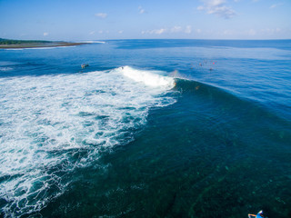 leaky peak perfection a-frame lines blue horizon sumbawa surfers left right takeoff aerial view