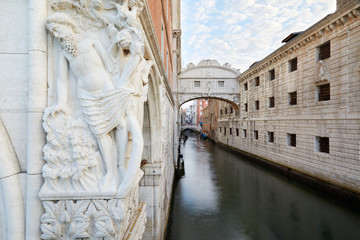 Bridge of Sighs, wide angle view with statue in a calm morning in Venice, Italy
