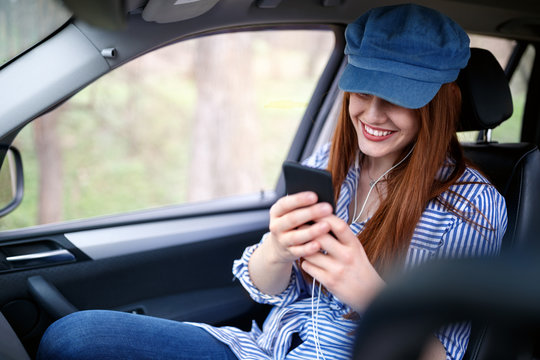 Woman texting message in car