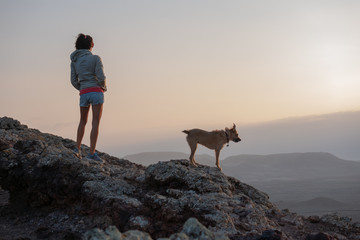 girl on the top of the volcano with her dog